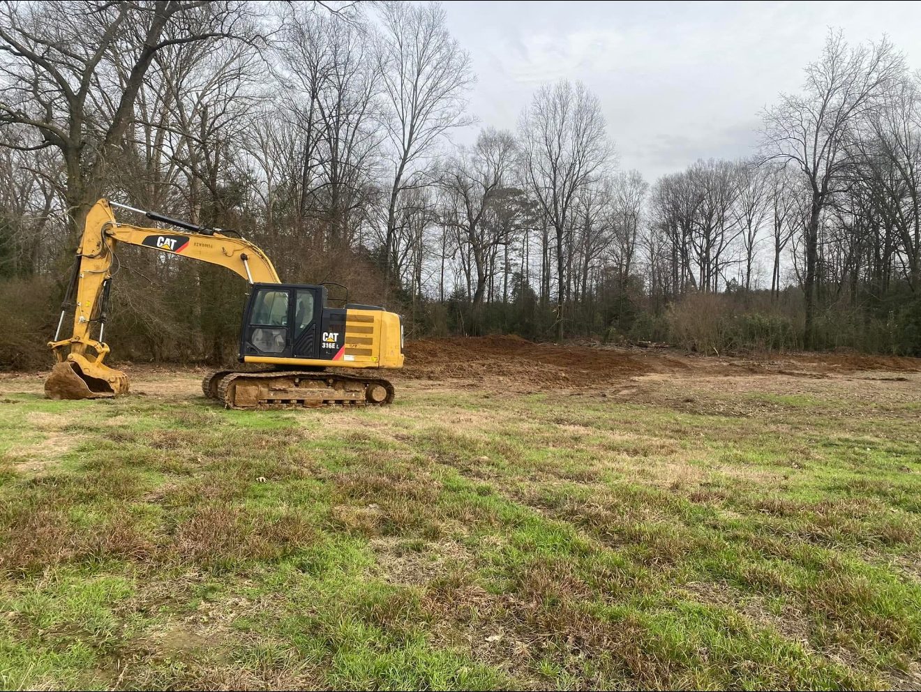 CAT 316 excavator on a cleared land project in Arkansas