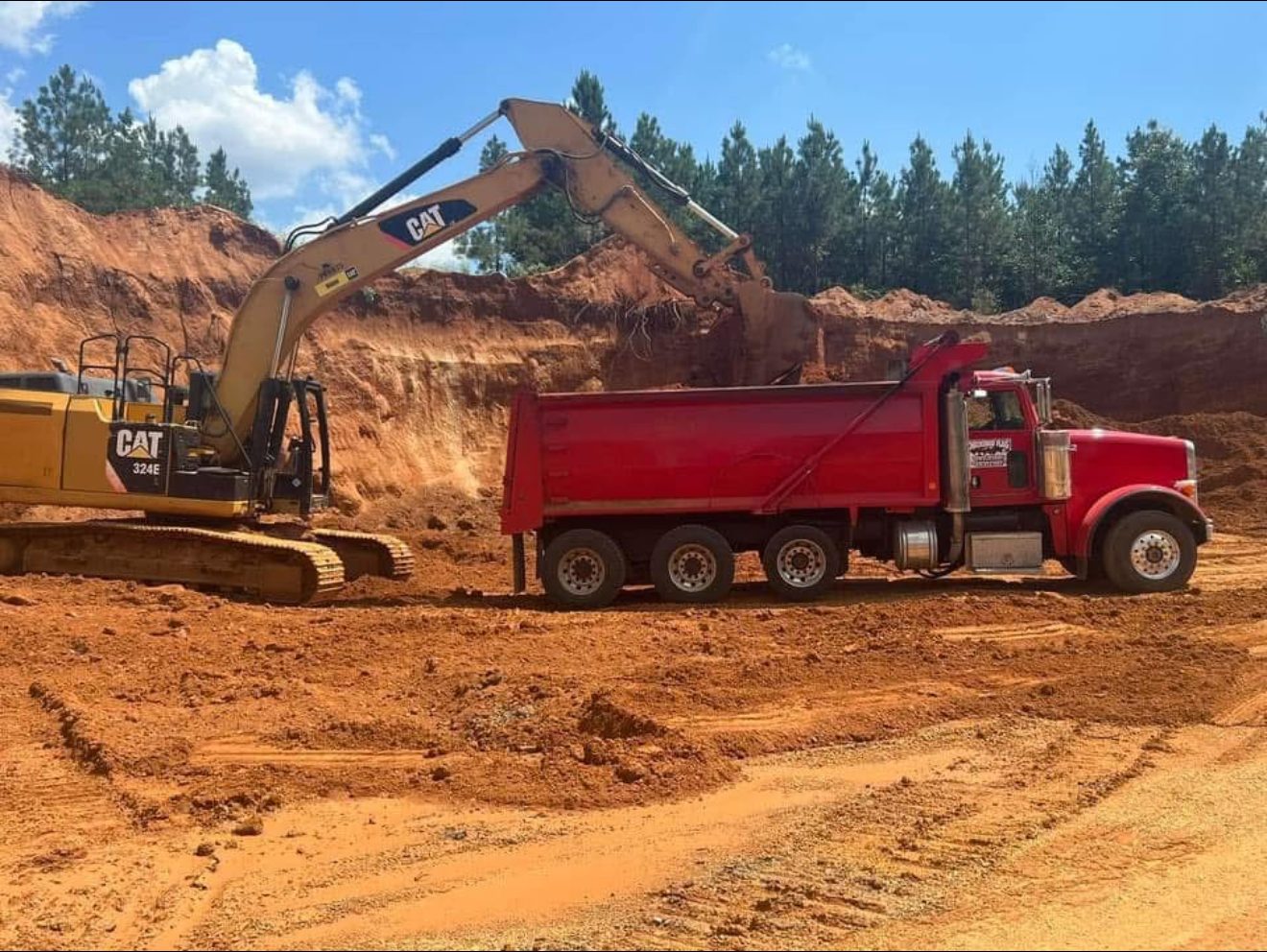 Excavator loading dump truck on Arkansas job site