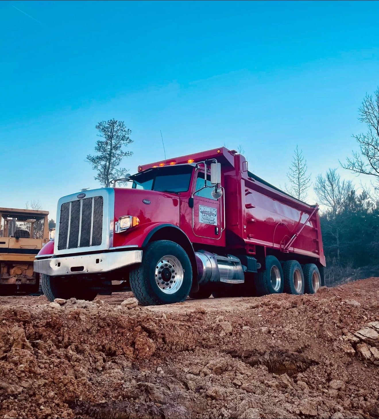 Red Peterbilt dump truck for land clearing hauls